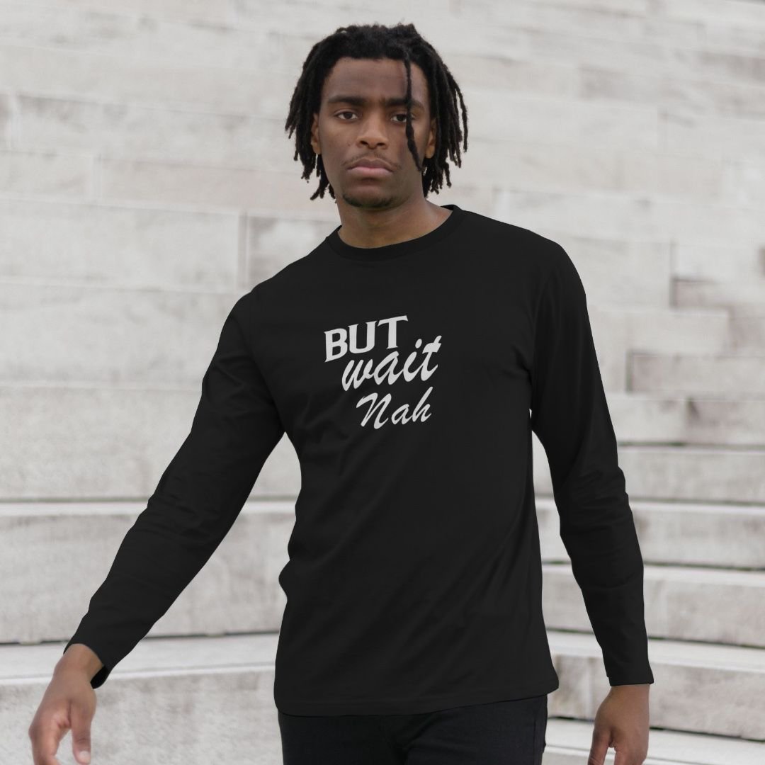 Man wearing a black teeshirt with white wording saying Rice Peas Tings