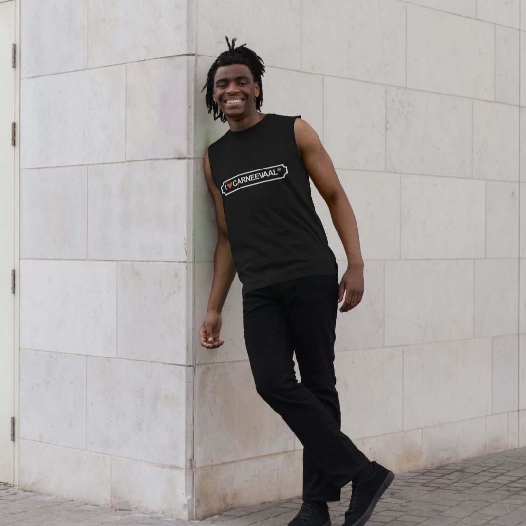 Man posing against a wall wearing black, organic, vest top