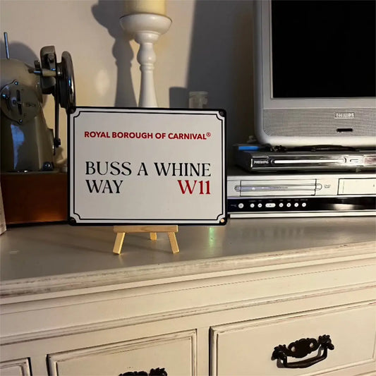 Buss A Whine Way W11 decorative street sign displayed on a small wooden easel atop a vintage painted chest of drawers