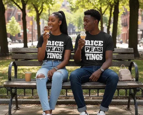 Man and woman sitting on a park bench eating ice cream in matching RICE PEAS TINGS t-shirts