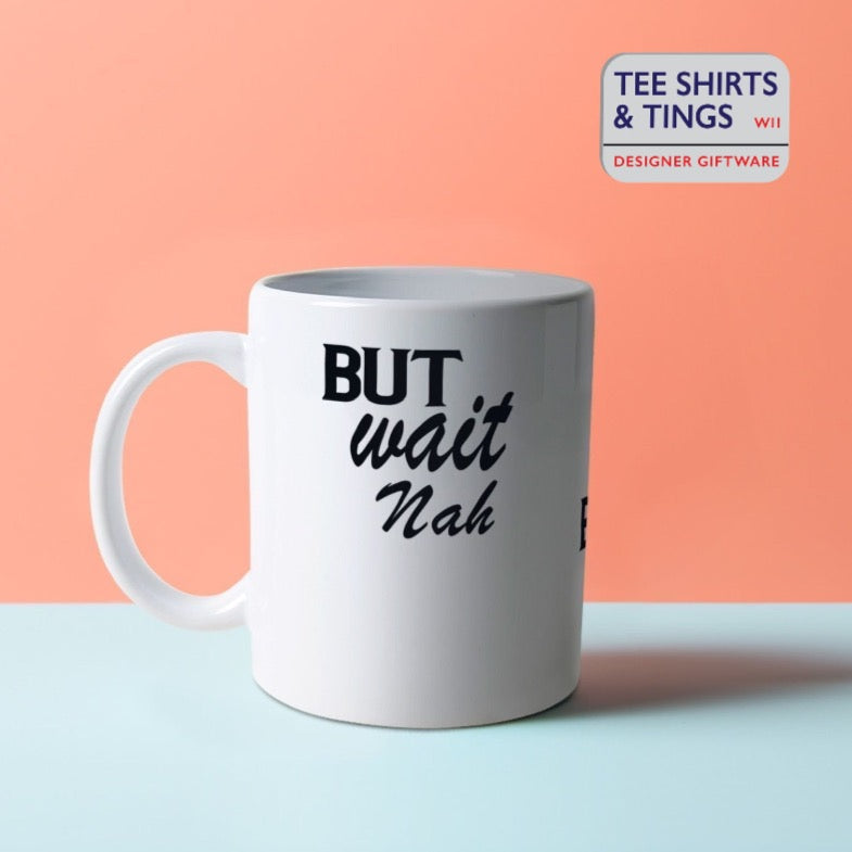 But Wait Nah white mug with black font displayed against a split coloured orange and blue surface - left view