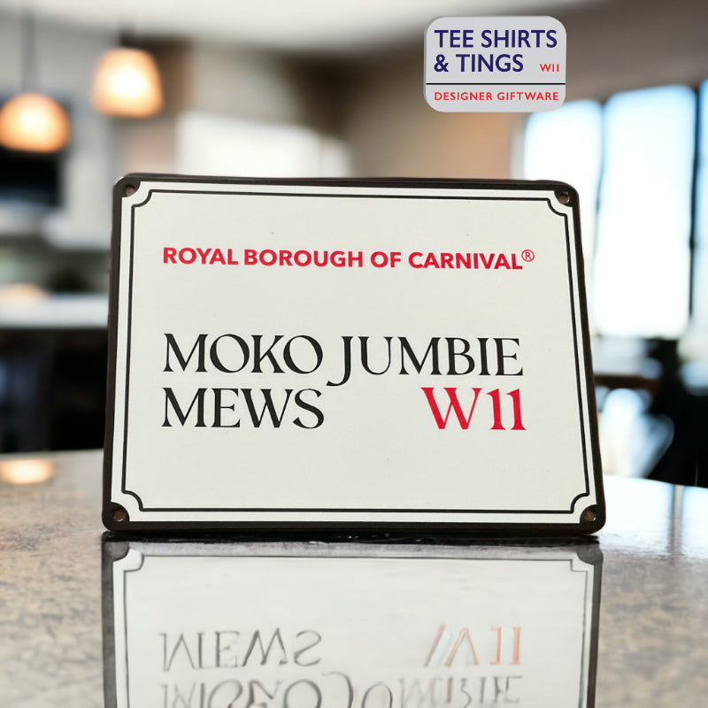 Moko Jumbie Mini Metal street sign on a reflective work surface