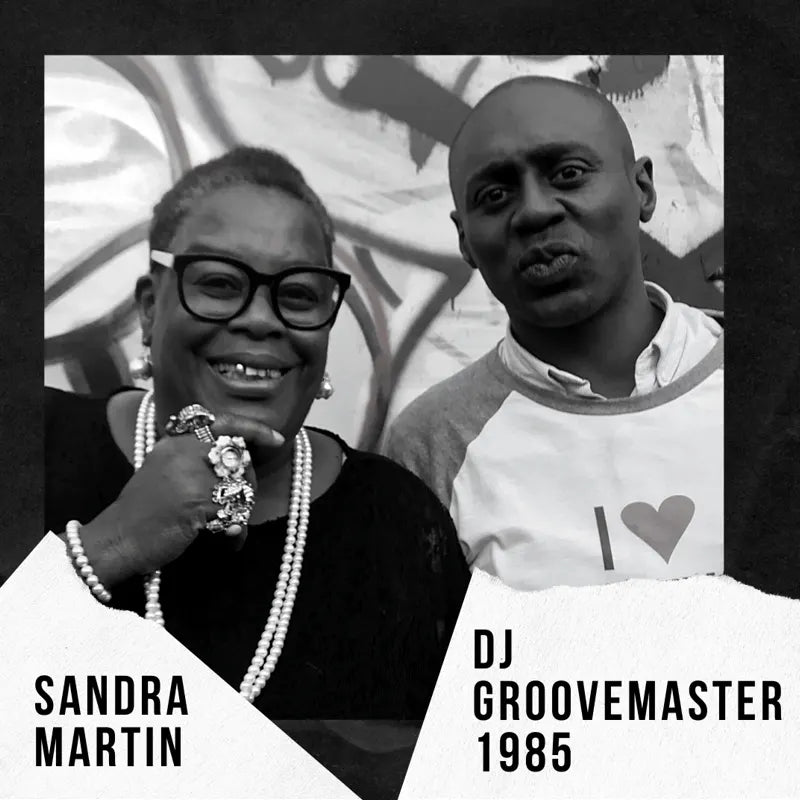 Black and white portrait of Sandra Martin and DJ GrooveMaster 1985 posing at the 50th anniversary celebration of Mangrove
