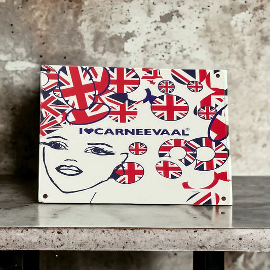 UK decorative carnival art mini sign styled upright on a polished stone surface against a textured wall