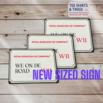 We On De Road new sized sign on wooden surface