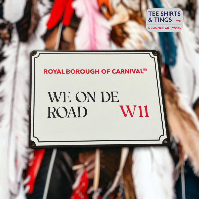 We On De Road mini street sign on background of blurred feathers
