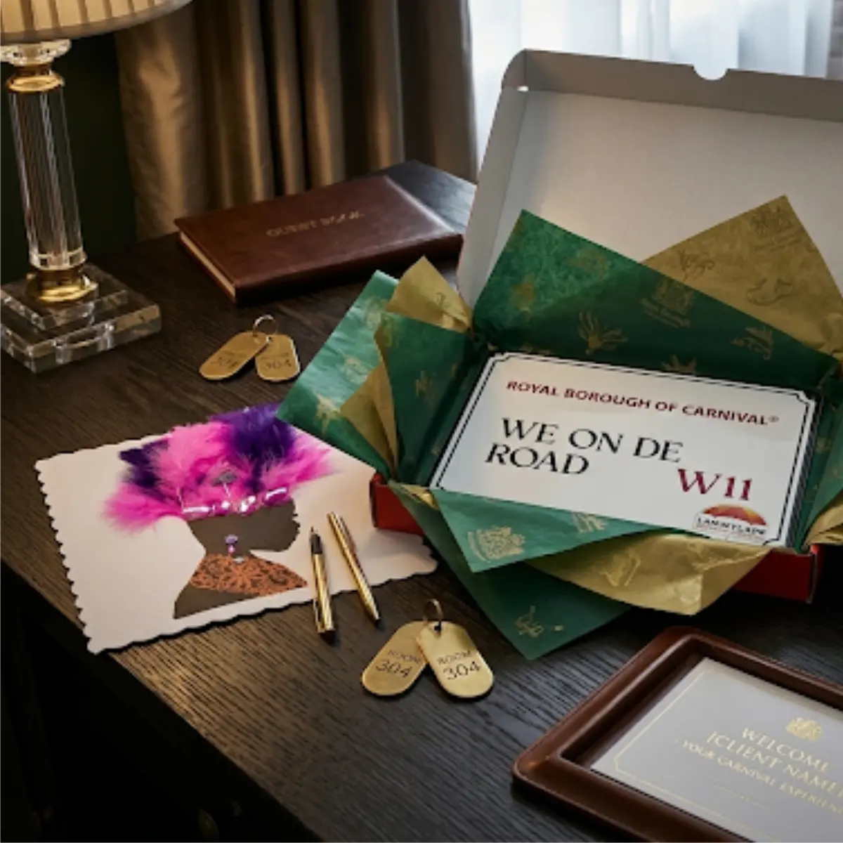 We On De Road W11 mini decorative sign presented in tissue-lined gift packaging alongside brass hotel keys and luxury stationery