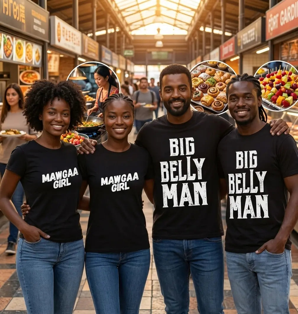 Four friends smiling in an indoor food market wearing black 'Mawgaa Girl' and 'Big Belly Man' typography t-shirts