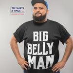 Man standing with hands on his hips. He is wearing a black teeshirt with the white wording saying Big Belly Man 100% organic cotton