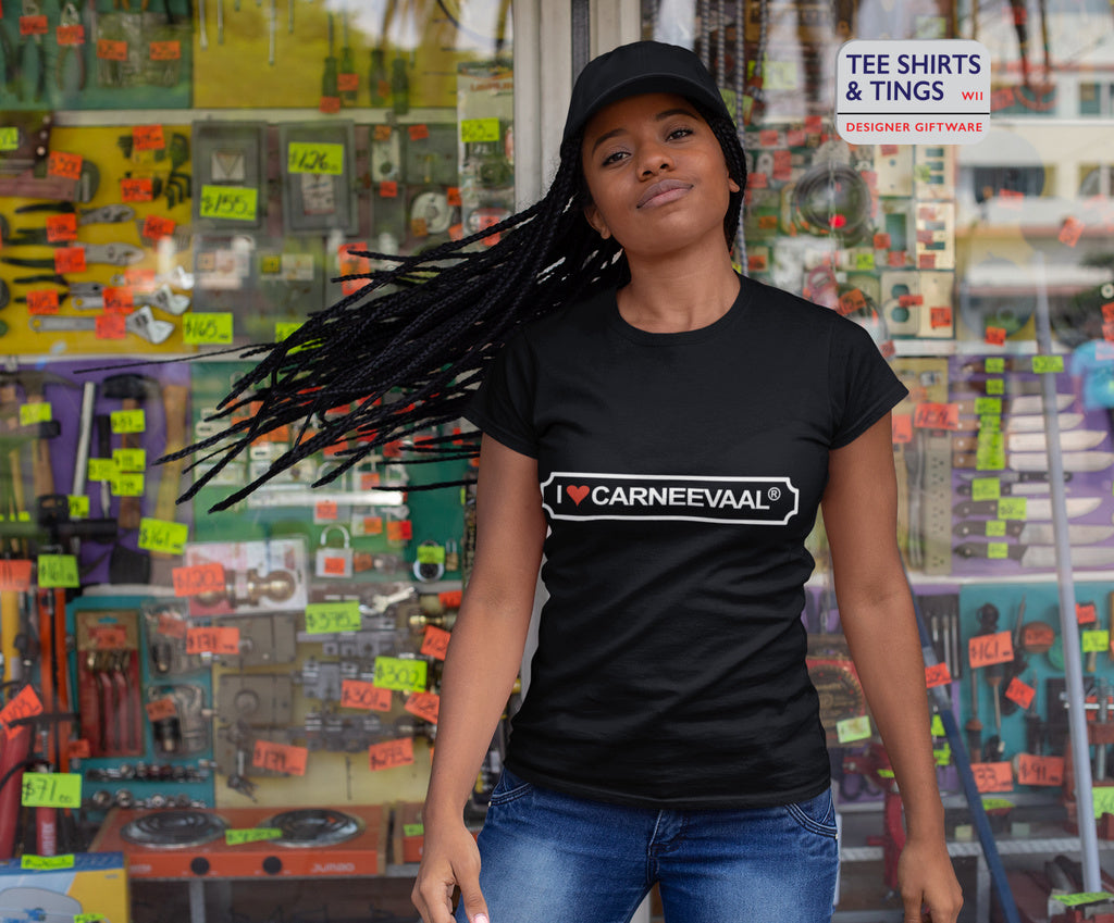 Young woman with swinging hair under a baseball cap wearing 100% Organic Cotton Black Women's Teeshirt featuring I ❤️ CARNEEVAAL®️