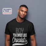 Man in studio wearing 100% organic black cotton teeshirt with white wording which says Boy You Sweet Like Chocolate. 100% organic cotton